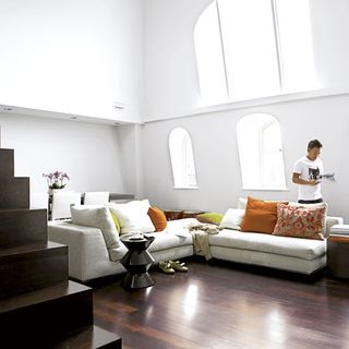 living room with white wall and sofa set cushions