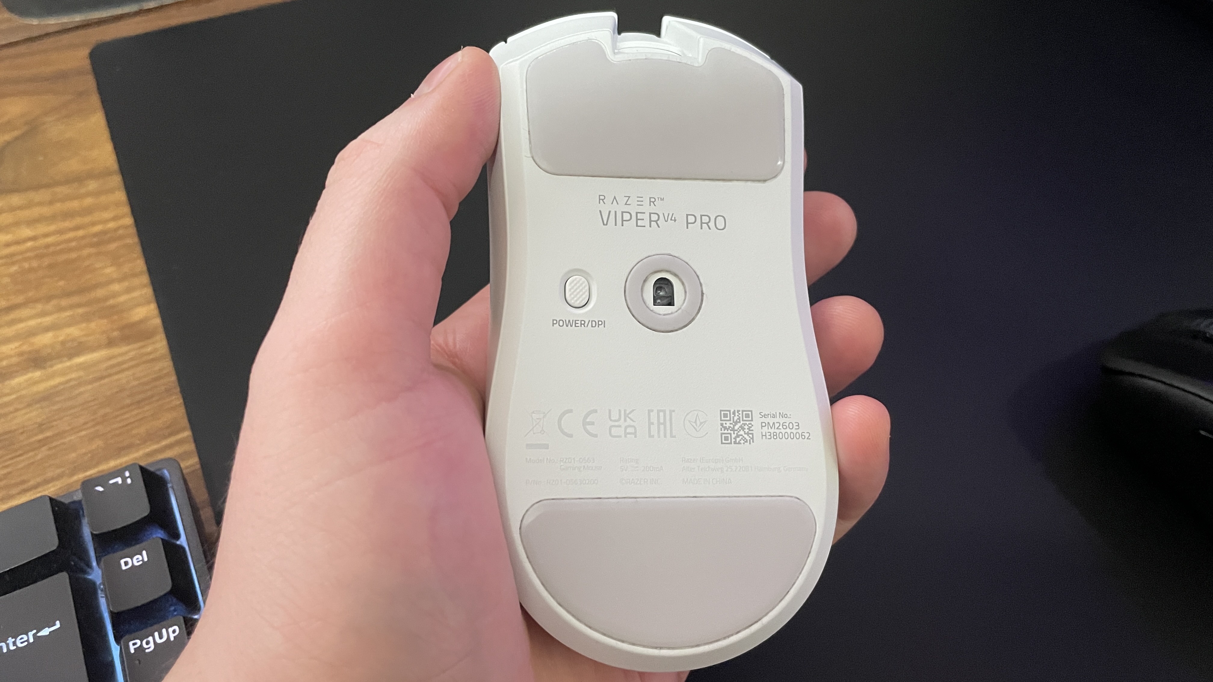 The underside of a Razer Viper V4 Pro gaming mouse in-hand, showing its skates.