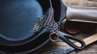 Cast iron being cleaned by a chainmail scrubber