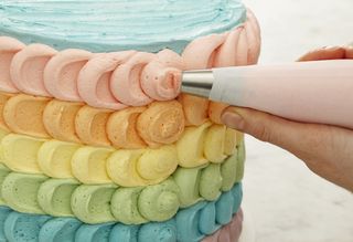 Decorating a cake with piping.