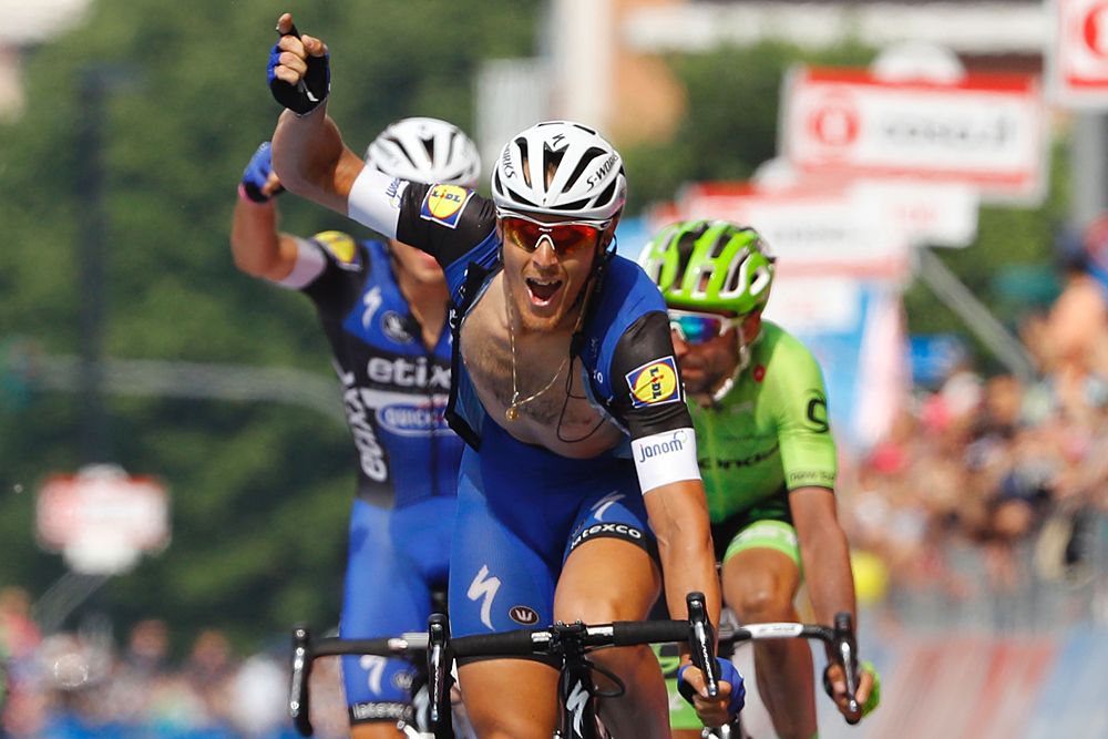 Matteo Trentin (C) celebrates as he crosses the finish line to win the 18th stage of the 99th Giro d'Italia