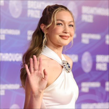 Gigi Hadid wears a bridal white nostalgic halter dress on the red carpet