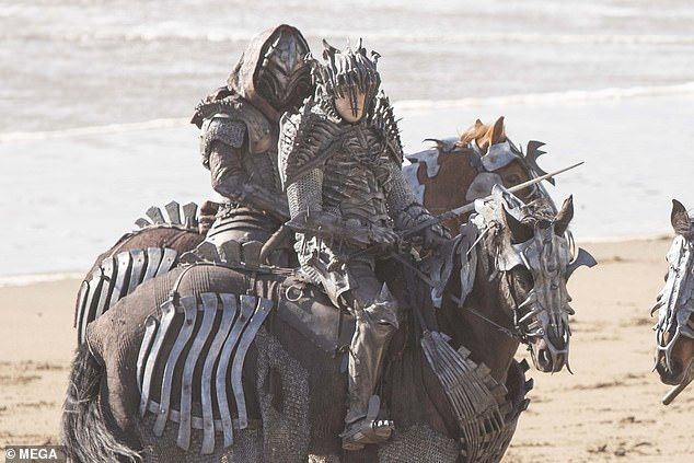 Actors in bony armor on horseback