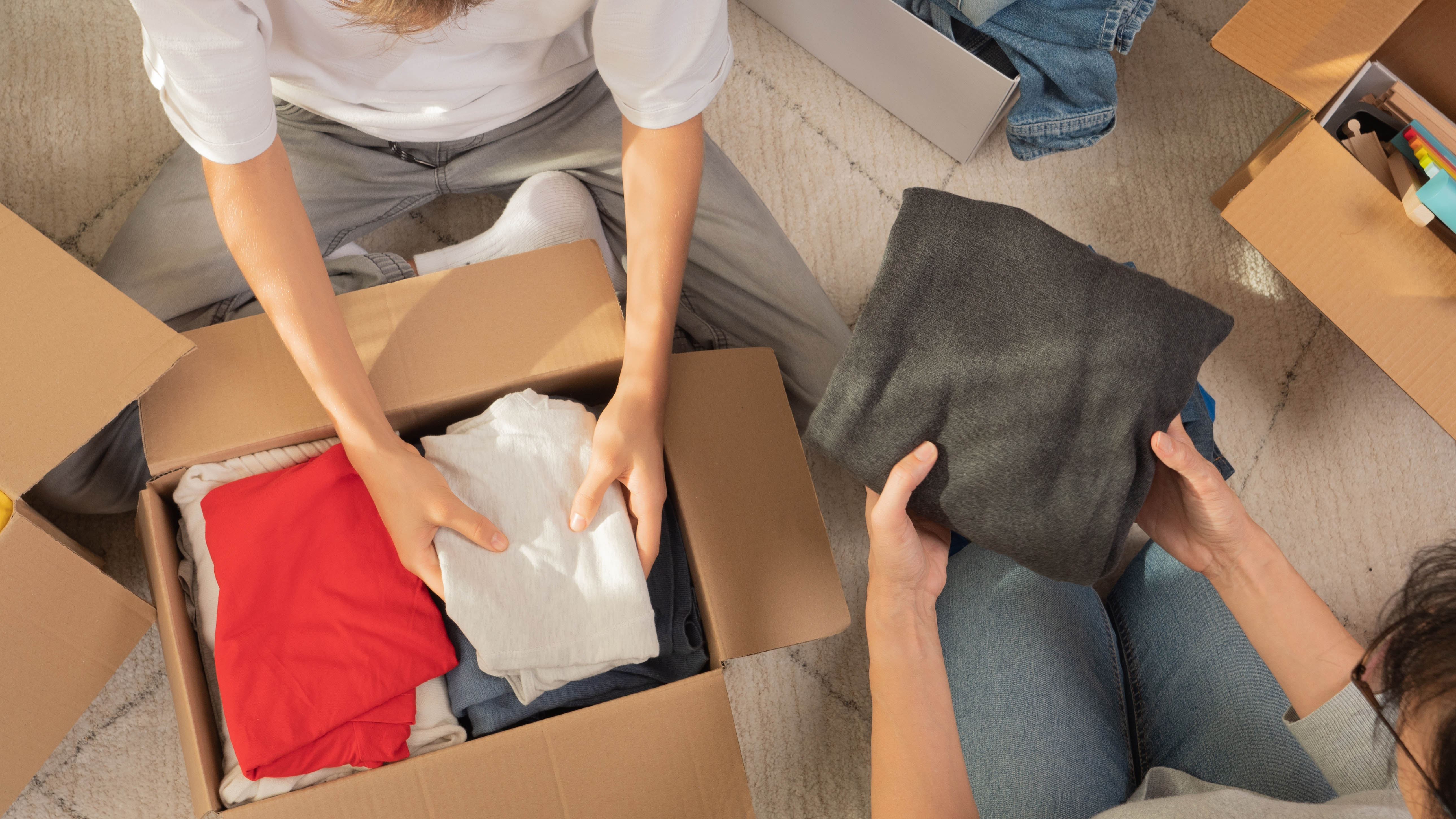 Decluttering clothes into boxes