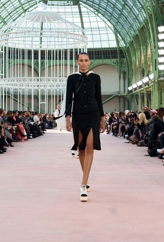 A model walking in the spring summer 2025 Chanel show at the Grand Palais during Paris Fashion Week.