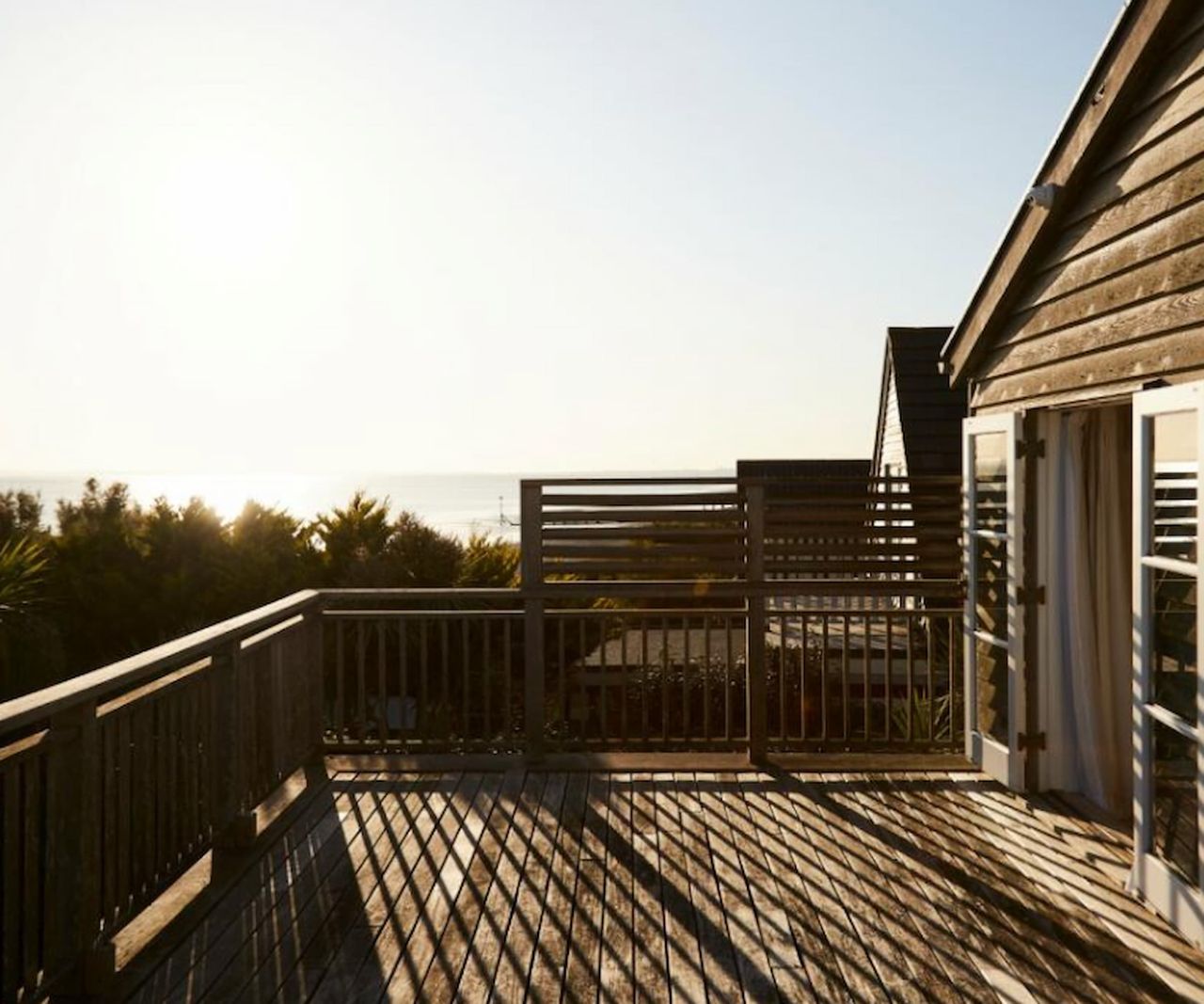A balcony for a master bedroom with views of a beach