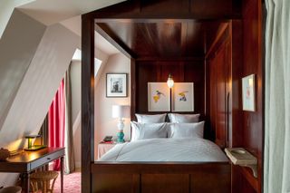 A glossy burgundy hotel bedroom