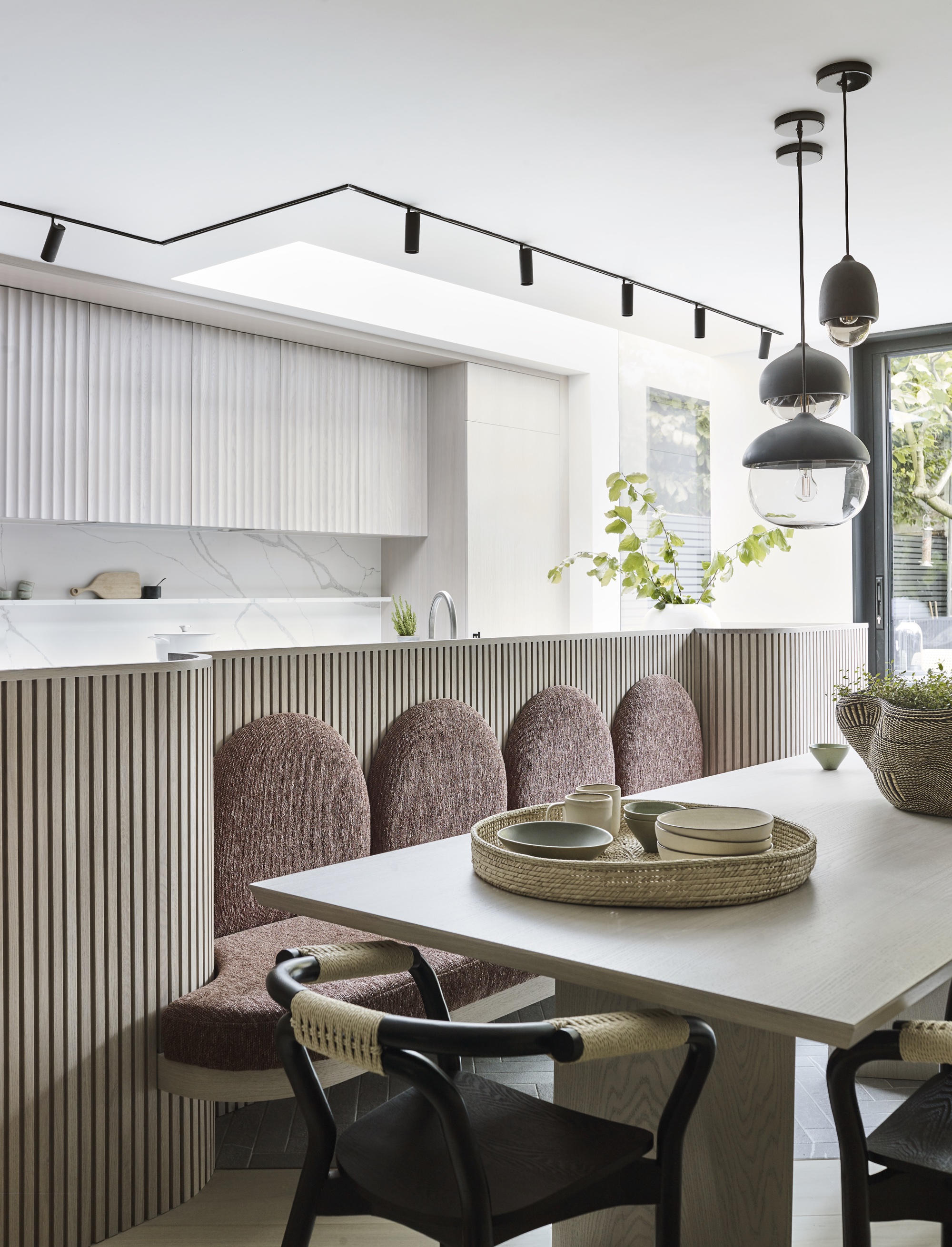 small apartment organization with banquette seating in kitchen by Gunter & Co