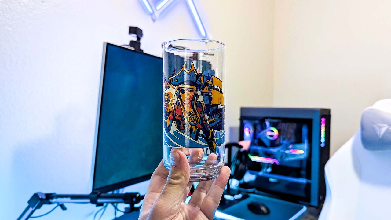 An Xbox x IHOP collectible glass held in a hand, featuring unique art from Sea of Thieves.