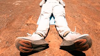 Feet of runner lying on ground