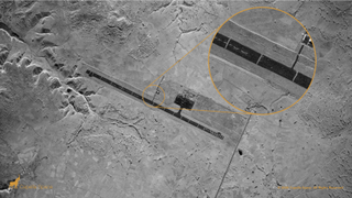 This SAR image of the Axum Airport shows 23 trenches dug perpendicularly across the runway to prevent its usage during the Ethiopian Tigray conflict. A zoomed-in view displays the individual trenches in contrast to the dark tarmac as well as debris cluttering the runway’s surface. The airport was recaptured by Ethiopian government forces from the Tigray People's Liberation Front, who were accused of sabotaging the airfield before losing control to federal forces.