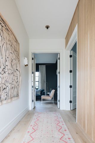 modern hallway with runner, artwork and timber cabinets