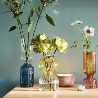 A group of three colorful vases on a table