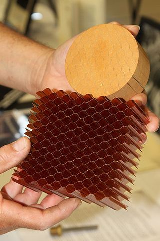 This view shows a bare honeycomb structure and one that has been filled with Avcoat using Textron’s “gunning” process.