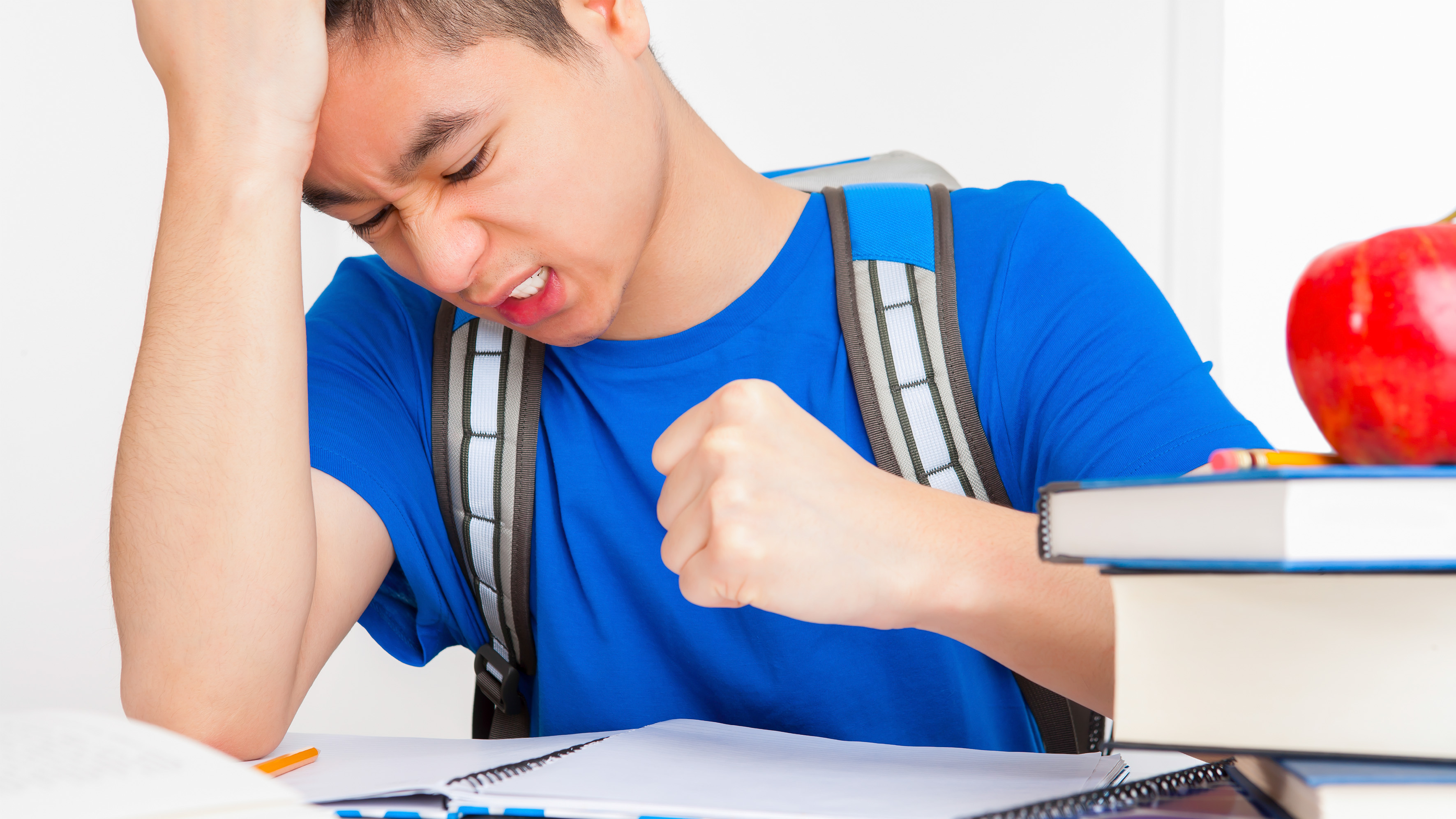 A frustrated teenager clenches his fist.