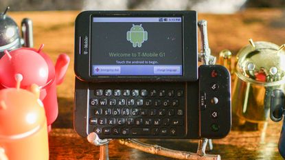 T-Mobile G1 phone with Android vinyl figurines