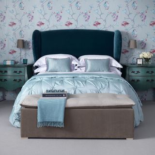 bedroom with floral wallpaper and blue bed