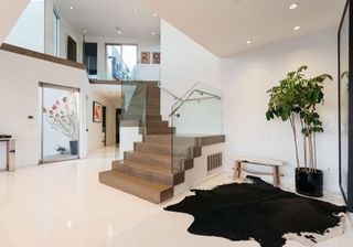 hallway with stair case and white wall