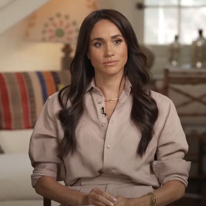 Meghan Markle wears a linen shirt by Ralph Lauren with a cartier necklace for her CBS interview