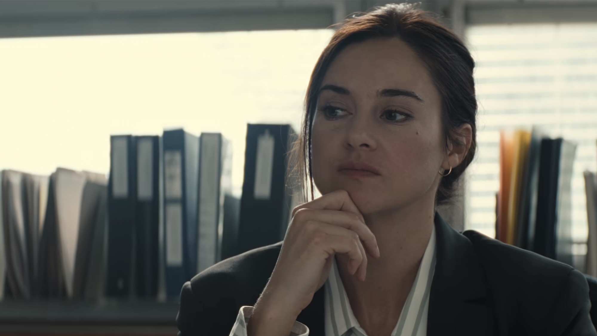 Shailene Woodley wearing a blazer and looking at a computer in Unabomber. 