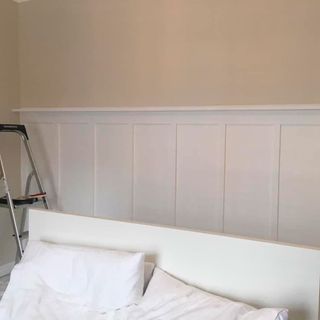 panelled wall behind bed