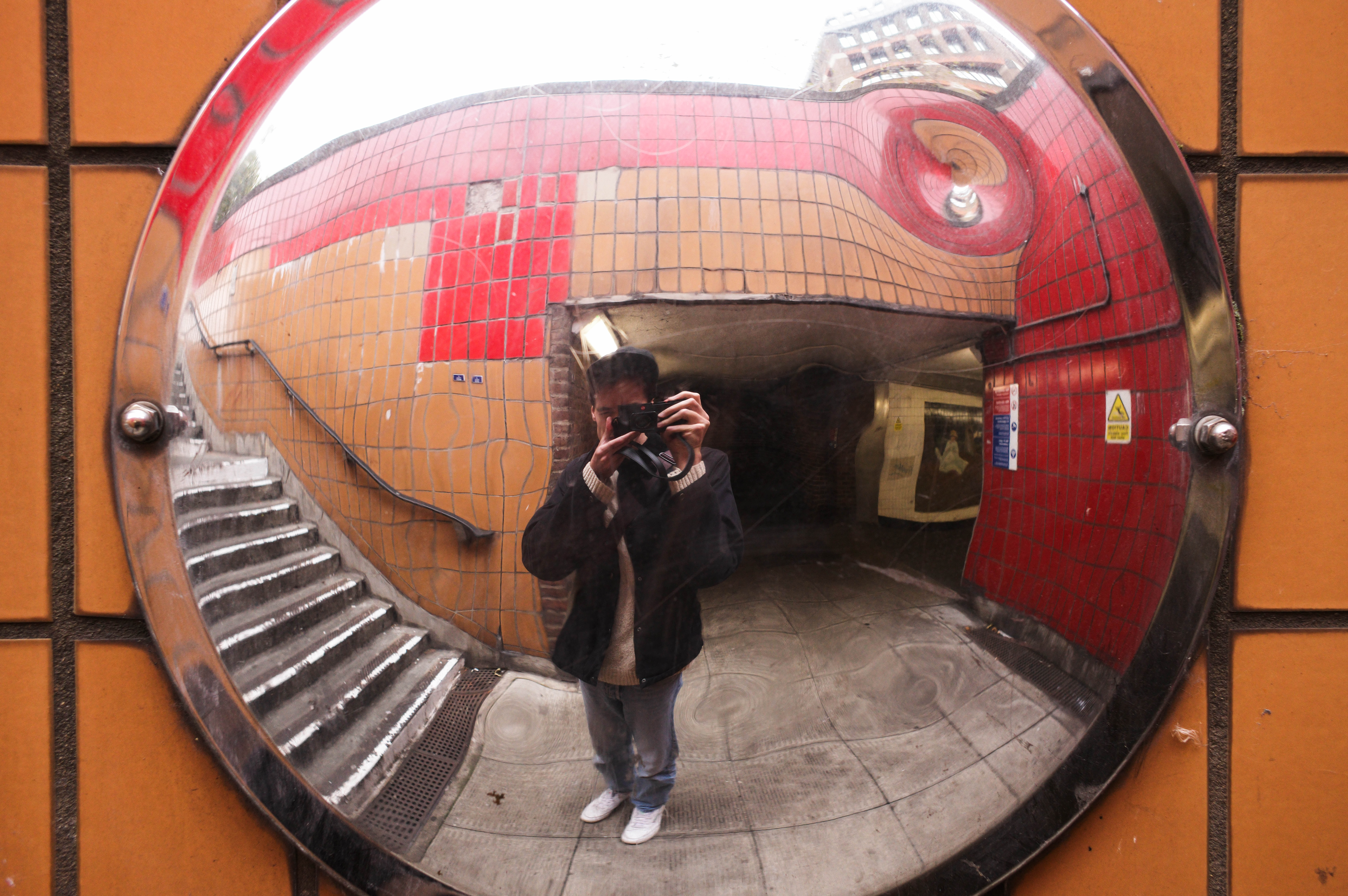 Person taking a photo reflected in a mirror