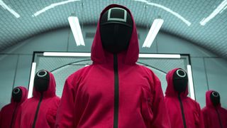 Squid Game's masked enforcers line up in a V formation