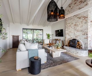 Large living room with exposed brick fireplace and waslls and cielings painted in City Loft by Sherwin Williams