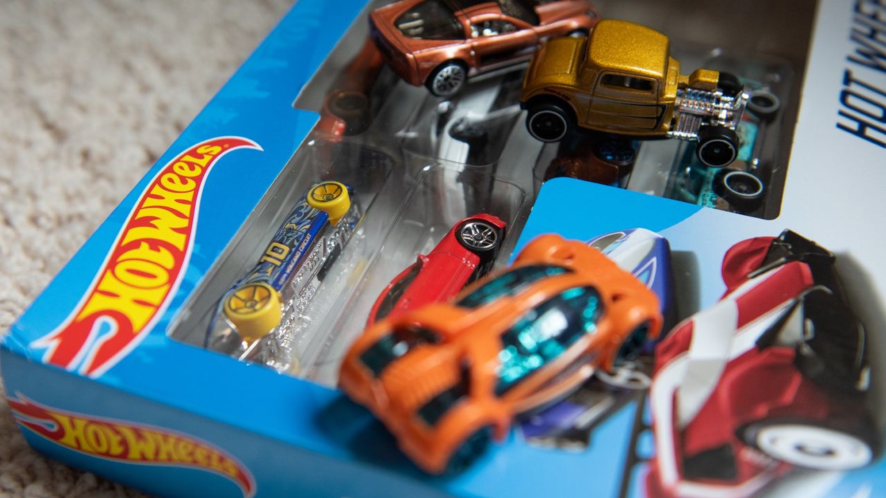 Hot Wheels cars atop their packaging