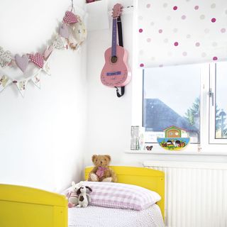 modern kids room with white wall and yellow bed