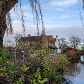 Exterior shot of 5 bed period moated house and garden in Essex. A 16th century house with five bedrooms and a moat, home of Lynsey and Paul Cross and their family in Essex.