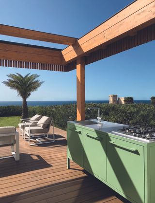 outdoor kitchen with green cabinets