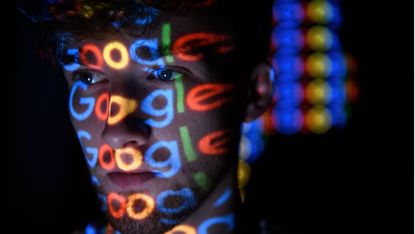 The Google logo is projected onto a man