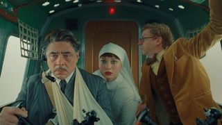 Benicio Del Toro, Mia Threapleton and Michael Cera in the cockpit of a plane in The Phoenician Scheme