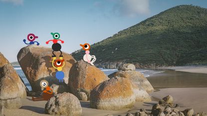 A group of Big Walk characters explore a pile of rocks on a beach