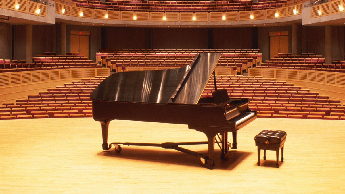 Grand Piano on a stage in an empty theatre 