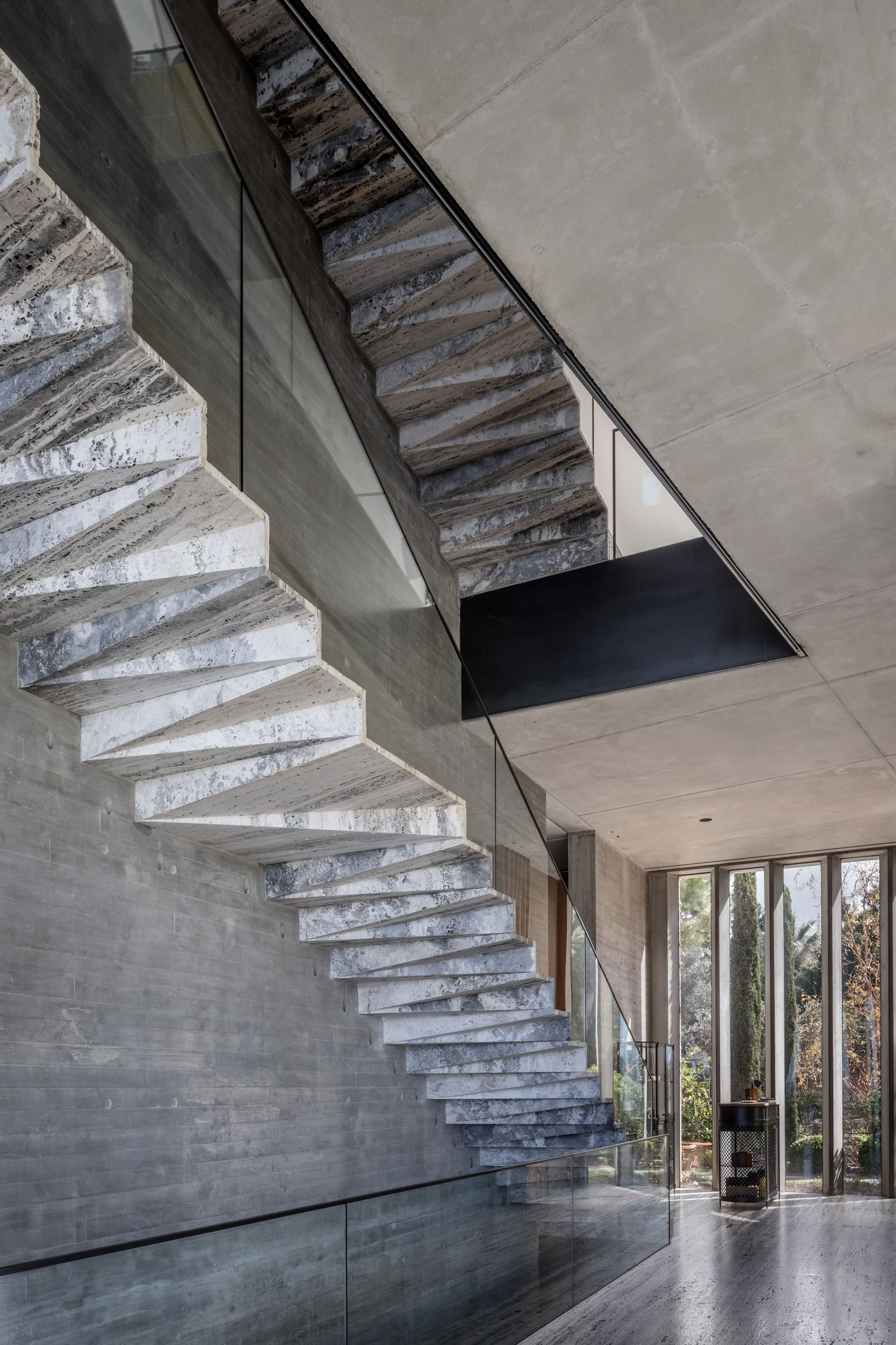 This brutalist home features a dramatic matte black kitchen | Livingetc
