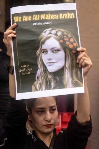 People hold signs and chant slogans during a protest over the death of Iranian Mahsa Amini outside the Iranian Consulate on September 21, 2022 in Istanbul,Turkey. Mahsa Amini fell into a coma and died after being arrested in Tehran by the morality police, for allegedly violating the countries hijab rules. Amini's death has sparked days of violent protests across Iran, which has so far seen more the five people killed.