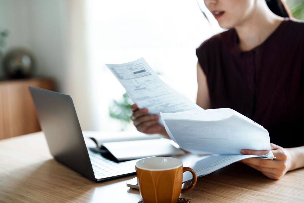 Woman shocked when looking at her rising bills