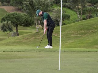 Barry Plummer addressing the ball for a chip shot from off the green