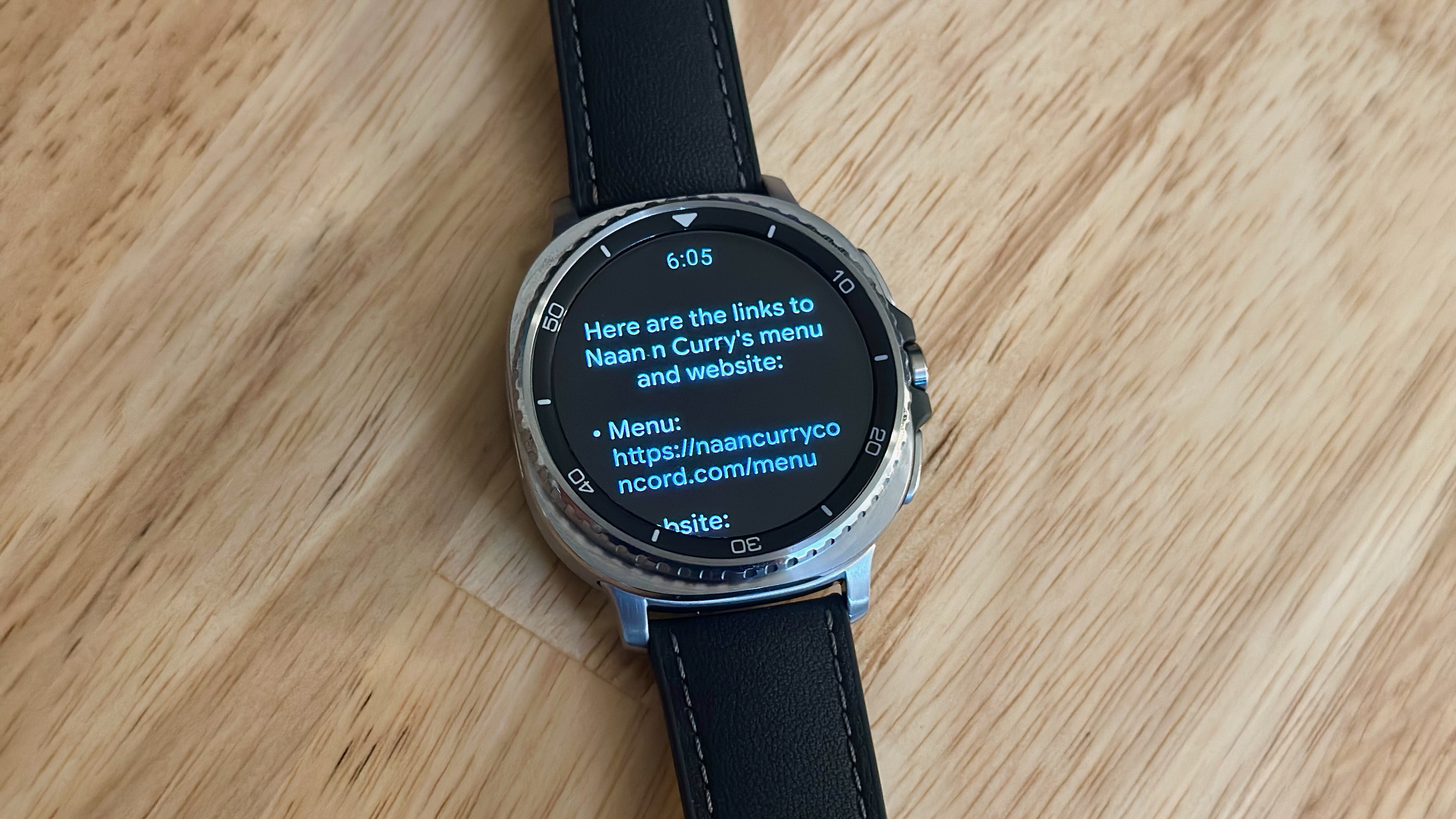 The Samsung Galaxy Watch 8 Classic showing a Gemini response with websites for a nearby restaurant