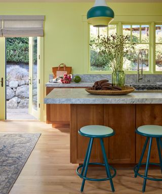 Vivid green kitchen with wooden kitchen island