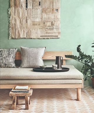 Green wall, notepads, tea tray, grey cushions