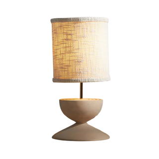 table lamp with sculptural base and rattan shade