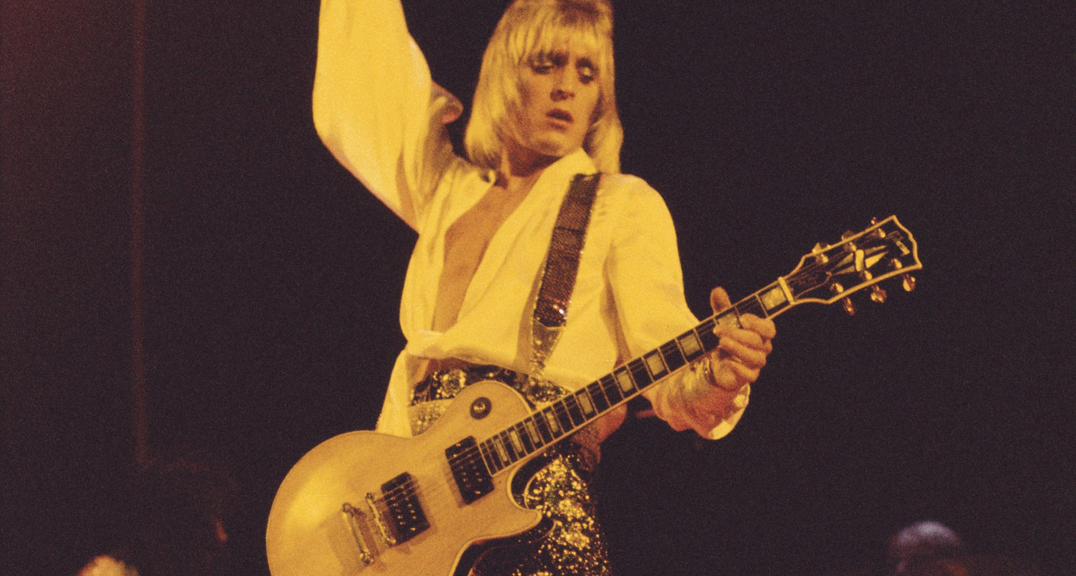 Mick Ronson plays his iconic Gibson Les Paul Custom onstage in 1973