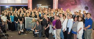 Styx poses with members of the New Horizons mission team, who greeted the band at the Kossiakoff Center Auditorium, Johns Hopkins Applied Physics Laboratory, in Laurel, Maryland.