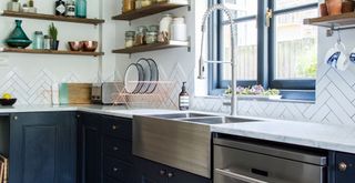 navy blue kitchen with stainless steel sink with mixer tap to ensure better rinsing when looking at how to clean a stainless steel sink