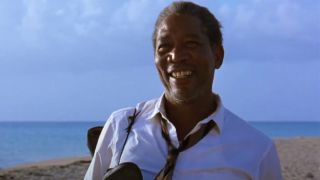 Morgan Freeman stands smiling on a beach in Mexico in The Shawshank Redemption.