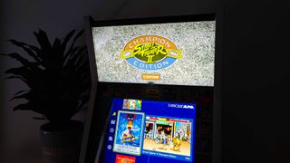 Evercade Alpha in dark with Street Fighter 2 marquee illuminated