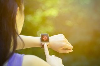 A person checking their heart rate with a smartwatch.